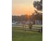 Beautiful sunrise view of the community with lush green lawns and a wooden fence at 5375 Glenhaven Dr, Cumming, GA 30041