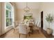 Elegant dining room featuring wainscoting, a large window, chandelier, and seating for six guests at 5375 Glenhaven Dr, Cumming, GA 30041