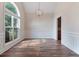 Bright dining room with hardwood floors, wainscoting details, and a large window providing ample natural light at 5375 Glenhaven Dr, Cumming, GA 30041