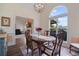 Elegant dining room with hardwood floors, a large arched window, and a view into the cozy living area at 5375 Glenhaven Dr, Cumming, GA 30041