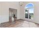 Spacious dining room showcases hardwood floors, wainscoting, and an arch window with views into living room at 5375 Glenhaven Dr, Cumming, GA 30041
