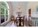 Formal dining room with a large window, elegant chandelier, and stylish decor, perfect for Gathering meals at 5375 Glenhaven Dr, Cumming, GA 30041