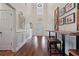 Bright foyer with hardwood floors, high ceilings, white trim, and decorative wall art, creating an inviting entrance at 5375 Glenhaven Dr, Cumming, GA 30041