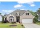 Charming single-Gathering home with a well-manicured lawn and attached two-car garage at 5375 Glenhaven Dr, Cumming, GA 30041