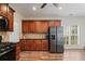 Kitchen featuring stainless steel refrigerator, wood cabinets, and a view of the backyard at 5375 Glenhaven Dr, Cumming, GA 30041