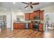 Well-appointed kitchen with stainless steel appliances, wooden cabinetry, hardwood floors, and an adjacent dining area at 5375 Glenhaven Dr, Cumming, GA 30041