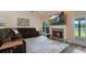 Comfortable living room with a fireplace, large windows, and a view of the outdoor space at 5375 Glenhaven Dr, Cumming, GA 30041