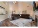 Spacious living room featuring vaulted ceilings, hardwood floors, a cozy fireplace, and comfortable seating arrangements at 5375 Glenhaven Dr, Cumming, GA 30041