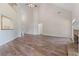 Open living room with hardwood floors, tall ceilings, a fireplace and seamless transitions to other spaces at 5375 Glenhaven Dr, Cumming, GA 30041
