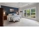 Main bedroom with a tray ceiling, a large window, and a plush bed with stylish furniture at 5375 Glenhaven Dr, Cumming, GA 30041