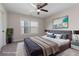 Staged bedroom with a modern bed, decorative pillows, artwork, and a view of the outside at 5375 Glenhaven Dr, Cumming, GA 30041