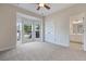 Bright main bedroom with a bay window, neutral carpeting, ceiling fan and ensuite bathroom access at 5375 Glenhaven Dr, Cumming, GA 30041