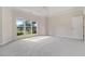A large main bedroom features a tray ceiling, a window, and a door at 5375 Glenhaven Dr, Cumming, GA 30041