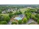 Aerial view of the community pool and recreation center surrounded by lush trees and landscaped lawns at 5375 Glenhaven Dr, Cumming, GA 30041