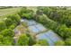 Aerial view of the immaculate tennis courts, shaded by mature trees, offer a fantastic amenity at 5375 Glenhaven Dr, Cumming, GA 30041
