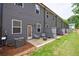 Backyard of townhome with a concrete patio, two chairs, small table, and gray privacy fences at 1624 Gunnin Nw Trce, Atlanta, GA 30318