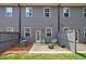 Townhome back patio view with furniture, privacy fence, and gray siding at 1624 Gunnin Nw Trce, Atlanta, GA 30318