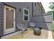 View of back patio with two chairs, side table, privacy fence, and gray siding at 1624 Gunnin Nw Trce, Atlanta, GA 30318
