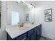 Stylish bathroom with double sink vanity, matte brass finishes, and decorative wall art at 1624 Gunnin Nw Trce, Atlanta, GA 30318
