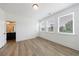 Light bedroom boasts wood-look floors, bright windows, and access to an ensuite bathroom at 1624 Gunnin Nw Trce, Atlanta, GA 30318