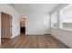 Spacious bedroom featuring wood-look flooring with an ensuite bathroom and bright windows at 1624 Gunnin Nw Trce, Atlanta, GA 30318