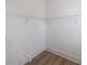Walk-in closet with installed white wire shelving and wood look floors at 1624 Gunnin Nw Trce, Atlanta, GA 30318