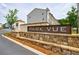 Stone signage with the community name and professionally landscaped entrance, offering a warm welcome at 1624 Gunnin Nw Trce, Atlanta, GA 30318
