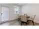 A dining table set with four chairs in a well-lit area with light hardwood floors at 1624 Gunnin Nw Trce, Atlanta, GA 30318
