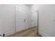 Clean white entryway with wood-look floors, a full length mirror, and white doors at 1624 Gunnin Nw Trce, Atlanta, GA 30318