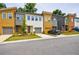 Exterior street view of modern townhomes showcasing colorful exteriors and attached garages at 1624 Gunnin Nw Trce, Atlanta, GA 30318