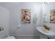 Half bathroom with modern fixtures, stylish mirror, and colorful artwork at 1624 Gunnin Nw Trce, Atlanta, GA 30318