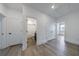 Hallway featuring neutral walls, wood-look floors, storage closets, and bathroom and bedroom access at 1624 Gunnin Nw Trce, Atlanta, GA 30318