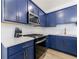 A close-up of the kitchen with modern appliances, blue cabinets, and white subway tile backsplash at 1624 Gunnin Nw Trce, Atlanta, GA 30318