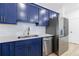Modern kitchen showcases stainless steel appliances, blue cabinets, and a stylish white backsplash at 1624 Gunnin Nw Trce, Atlanta, GA 30318