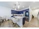 A modern kitchen features an island with seating, stainless steel appliances, and blue cabinets at 1624 Gunnin Nw Trce, Atlanta, GA 30318
