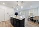 Kitchen with island, white countertop, blue cabinets, dining area, and light hardwood floors at 1624 Gunnin Nw Trce, Atlanta, GA 30318