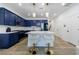 Stylish kitchen boasts an island with seating, modern lighting, blue cabinetry, and white subway tile at 1624 Gunnin Nw Trce, Atlanta, GA 30318