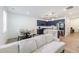 Open floor plan with blue kitchen, island, and bright living room featuring light hardwood floors and white couch at 1624 Gunnin Nw Trce, Atlanta, GA 30318