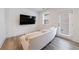 Bright living room with a TV, white couch, and a view of the outdoors at 1624 Gunnin Nw Trce, Atlanta, GA 30318