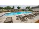 Community pool with lounge chairs, tables, and a fence, offering a relaxing outdoor space for residents at 1624 Gunnin Nw Trce, Atlanta, GA 30318