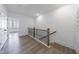 Upstairs hallway with railing and light hardwood floors at 1624 Gunnin Nw Trce, Atlanta, GA 30318
