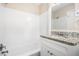 Clean bathroom with white tile, updated vanity with granite countertop, and modern fixtures at 2771 Dresden Trl, Atlanta, GA 30344