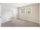 Bedroom featuring carpet floors, natural light from a window, and an adjoining bathroom at 2771 Dresden Trl, Atlanta, GA 30344