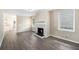 Spacious living room featuring a fireplace, wood floors, and natural light from several windows at 2771 Dresden Trl, Atlanta, GA 30344