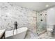 Bathroom with a glass-enclosed shower, soaking tub, and elegant marble tile and mosaic tile accents at 3019 Camden Way, Alpharetta, GA 30005