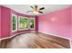 Bright bedroom with large windows offering scenic views, hardwood flooring and ceiling fan at 3019 Camden Way, Alpharetta, GA 30005