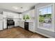 Bright kitchen features white cabinets, stainless steel appliances, and vinyl wood floors at 3019 Camden Way, Alpharetta, GA 30005