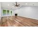 Open-concept living room with vinyl wood floors, vaulted ceiling and natural light from sliding glass doors at 3019 Camden Way, Alpharetta, GA 30005