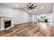 Light-filled living room with vinyl wood floors, a ceiling fan and open view of the modern kitchen at 3019 Camden Way, Alpharetta, GA 30005