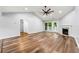 Open-concept living room with vaulted ceilings, fireplace, wood-look floors, and a ceiling fan at 3019 Camden Way, Alpharetta, GA 30005